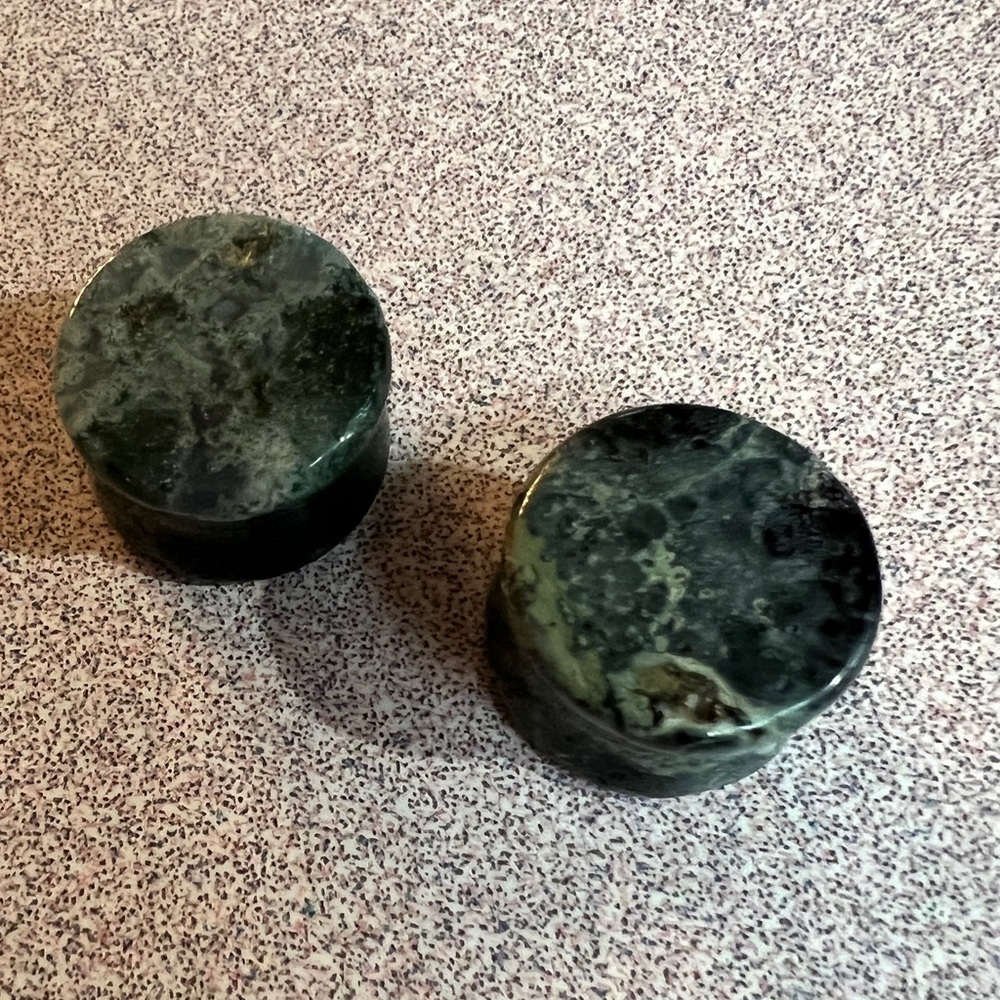 Pair of double flare green zebra jasper plugs for stretched earlobes.